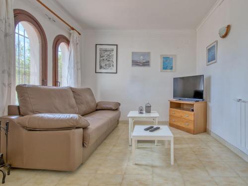 a living room with a couch and a tv at Holiday Home Peeters by Interhome in Calpe