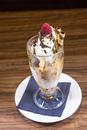 a ice cream sundae in a glass on a plate at Mondo Hotel in Coatbridge