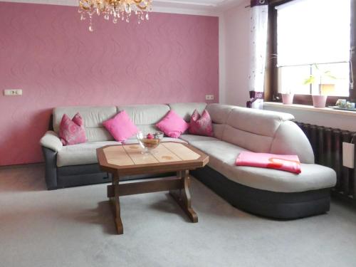 a living room with a couch and a table at Apartment Petra-2 by Interhome in Frankenhain