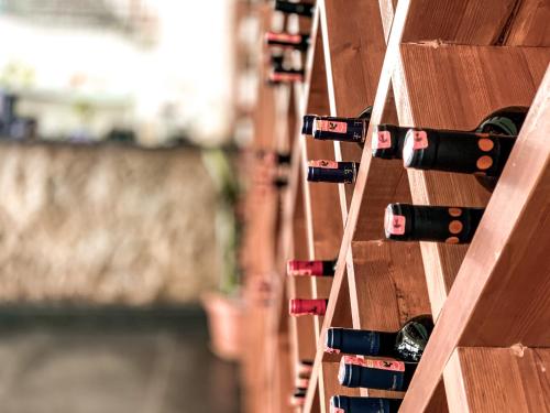 a bunch of wine bottles in a wine rack at Hotel Nimfa in Vlorë