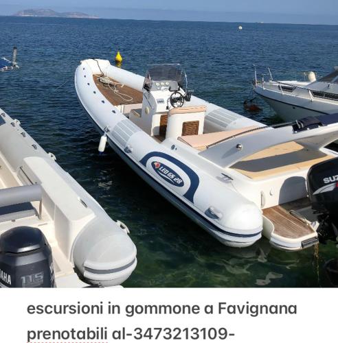 a white boat is parked in the water at Casale Belvedere vista mare in Valderice
