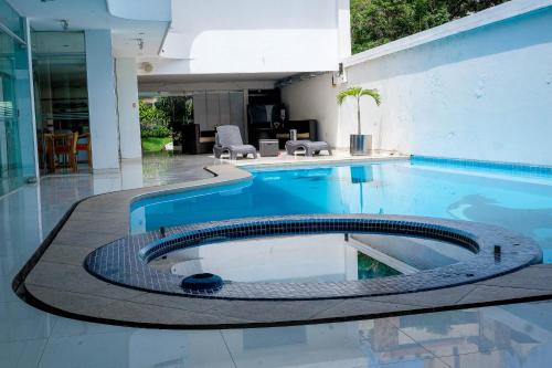a swimming pool in a house at Hotel Senses Equipetrol in Santa Cruz de la Sierra