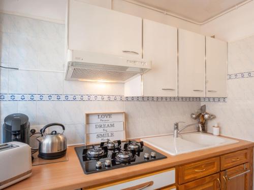 a kitchen with a stove top oven next to a sink at Apartment L'Amiral-1 by Interhome in Cagnes-sur-Mer