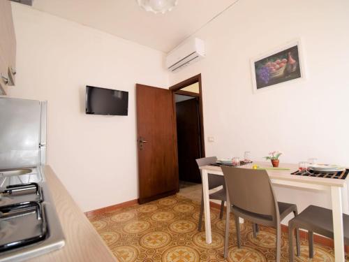 a small kitchen with a table and chairs in a room at Apartment Fiori di Sulla SinAgo by Interhome in Lascari