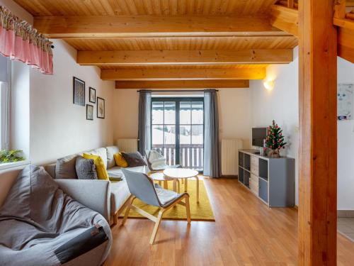 a living room with a couch and a table at Holiday Home Holiday Hill 67 by Interhome in Lauterwasser