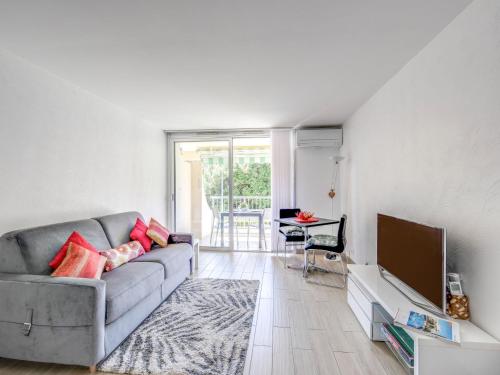 a living room with a couch and a tv at Studio Le Mexico-8 by Interhome in Saint-Raphaël