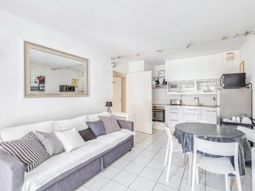 a living room with a couch and a table at Apartment Le Cesarée-5 by Interhome in Fréjus