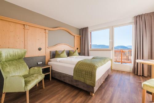 a hotel room with a bed and a balcony at Hotel Salten in Avelengo