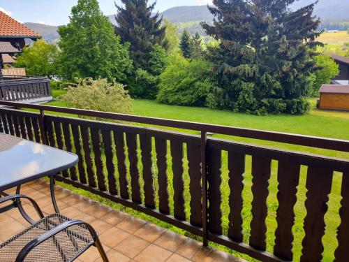 a balcony with a table and chairs and a view at Holiday Home Am Hohen Bogen-44 by Interhome in Arrach