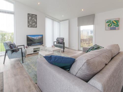 a living room with a couch and a tv at Holiday Home Ruisweg 38 by Interhome in Wemeldinge