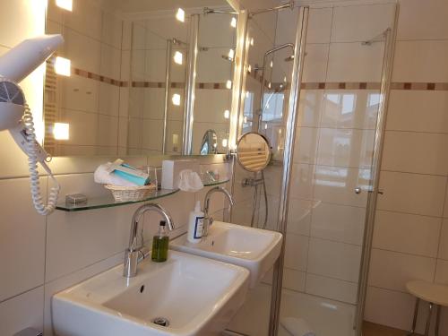 a bathroom with a sink and a shower at Bio- und Wellnesshotel Alpenblick in Höchenschwand
