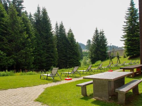 a group of picnic tables and chairs in a park at Apartment Panorama View 905 by Interhome in San Bernardino