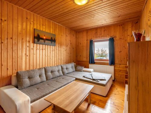 a living room with a couch and a table at Apartment Pistenblick-3 by Interhome in Hochrindl