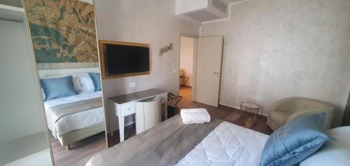 a small bedroom with a bed and a mirror at Amsterdam Suite Hotel & SPA in Rimini