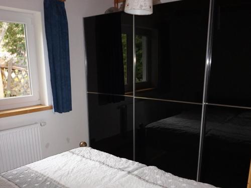 a bedroom with a mirrored cabinet and a bed at Holiday Home Pistenblick-4 by Interhome in Hochrindl