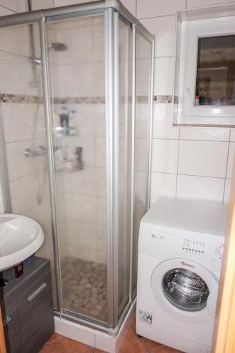 a bathroom with a washing machine and a washer at Holiday Home Pistenblick-4 by Interhome in Hochrindl