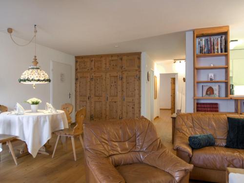 a living room with a table and a couch at Apartment Chesa Ginellas by Interhome in Sils Maria