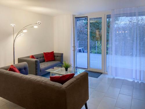 a living room with two couches and a table at Apartment Bella Vista - EG by Interhome in Magadino