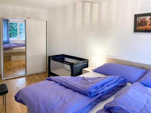 a bedroom with two beds and a mirror at Apartment Bella Vista - EG by Interhome in Magadino