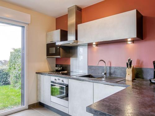 une cuisine avec un évier et une cuisinière dans l'établissement Apartment Les Hauts de Port Mer by Interhome, à Cancale