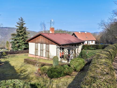 a small white house with a red roof at Holiday Home Měřín by Interhome in Rabyně