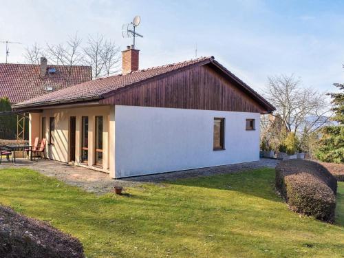 a small white house with a brown roof at Holiday Home Měřín by Interhome in Rabyně