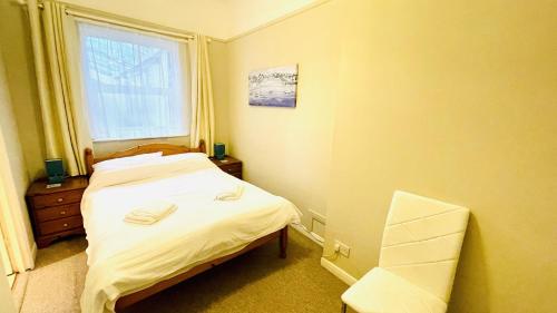 a small bedroom with a bed and a window at 2 Dartview - Close to the Water, River Views, Ground Floor Access in Dartmouth