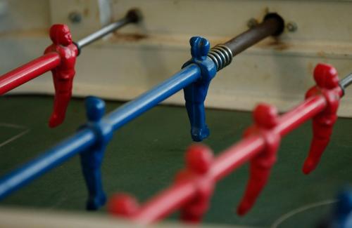 a group of red and blue toy people on a stick at La Trinidad Casa de Campo in San José