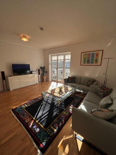 a living room with a couch and a table at Villa am Park in Bremerhaven