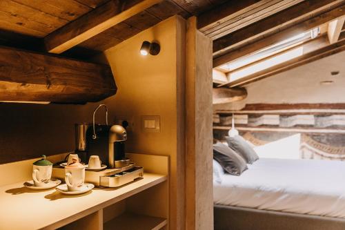 a room with a bed and a table with teaitures at Palazzo Feroci - Residenza d'epoca in Pisa