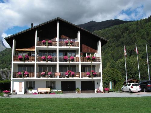 a large building with flowers on the balconies of it at Apartment Casa Yolanda Mireille by Interhome in Fieschertal