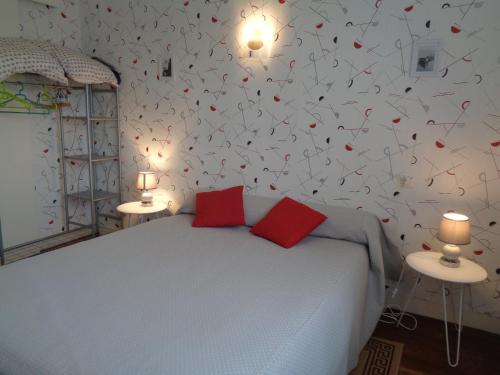 a bedroom with a bed with hearts on the wall at chambre d'hôte in Pontorson