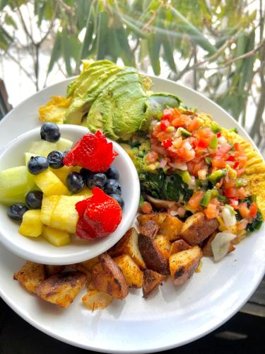 a plate with a salad and a bowl of food at Atlantic Beach Hotel Newport in Middletown