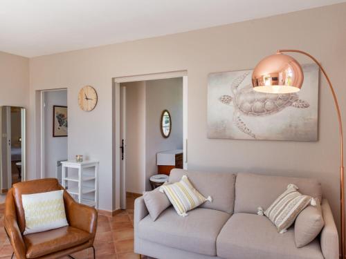 un salon avec un canapé et une chaise dans l'établissement Apartment Hameau la Madrague-26 by Interhome, à Saint-Cyr-sur-Mer