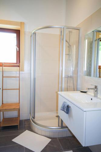 a bathroom with a shower and a sink at Chalet Stressless by Interhome in Presseggen