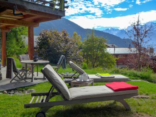 a patio with a table and a chair and a table at Chalet Filaos by Interhome in Verbier