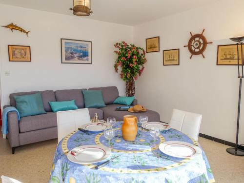 a living room with a table and a couch at Apartment Les Cyclades-9 by Interhome in Le Lavandou