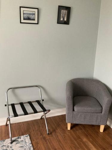 a chair sitting in a room next to a wall at Killilagh Accommodation in Doolin