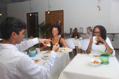 
people sitting at a table eating food at Sol Sanctum in Gros Islet
