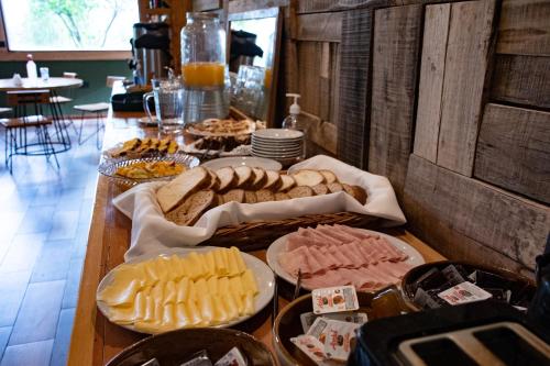 a table topped with lots of different types of food at Fitz Roy Hostería de Montaña - El Chaltén in El Chalten