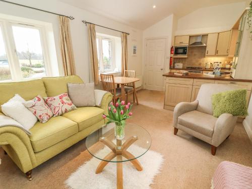 a living room with a couch and a table at Apple Tree Cottage in Windermere