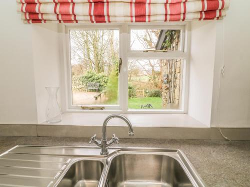 a kitchen sink in front of a window at Fleshbeck Cottage in Barbon