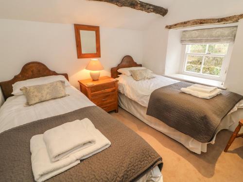 Postel nebo postele na pokoji v ubytování Fleshbeck Cottage