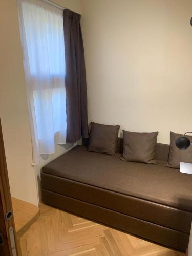 a couch sitting in a room with a window at Hotel Firenze in Fanano