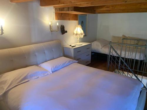 a bedroom with a bed and a desk with a lamp at Hotel Firenze in Fanano
