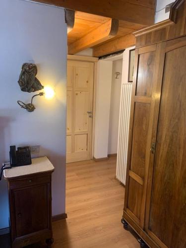 a room with a room with a wooden cabinet and a hallway at Hotel Firenze in Fanano