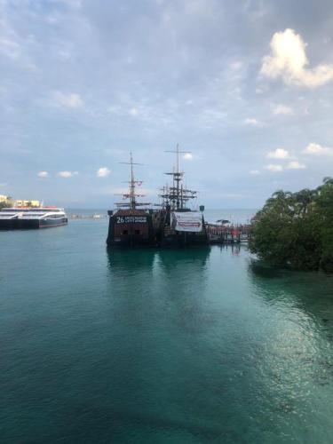 a large ship docked at a dock in the water at 777 LENDERMAN HoSTaL 777 in Cancún