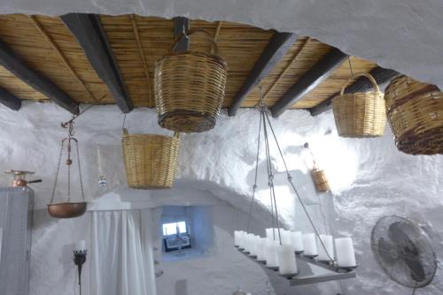 a room with wicker baskets hanging from the ceiling at Villa Romantica in Parikia