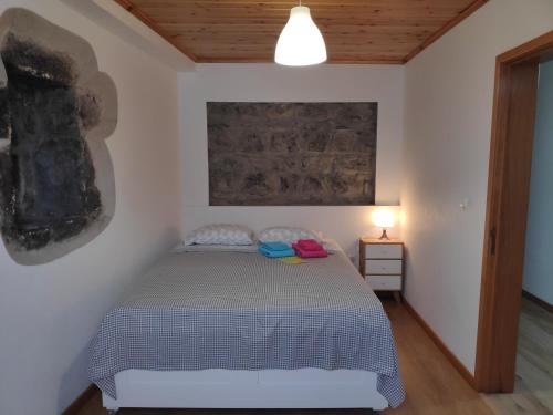 a bedroom with a bed in a room at By the Sea Azores in Ribeira Grande