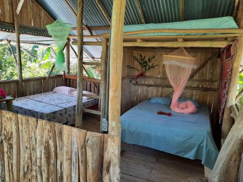 Μία ή περισσότερες κουκέτες σε δωμάτιο στο La Muñequita Lodge 2 - culture & nature experience